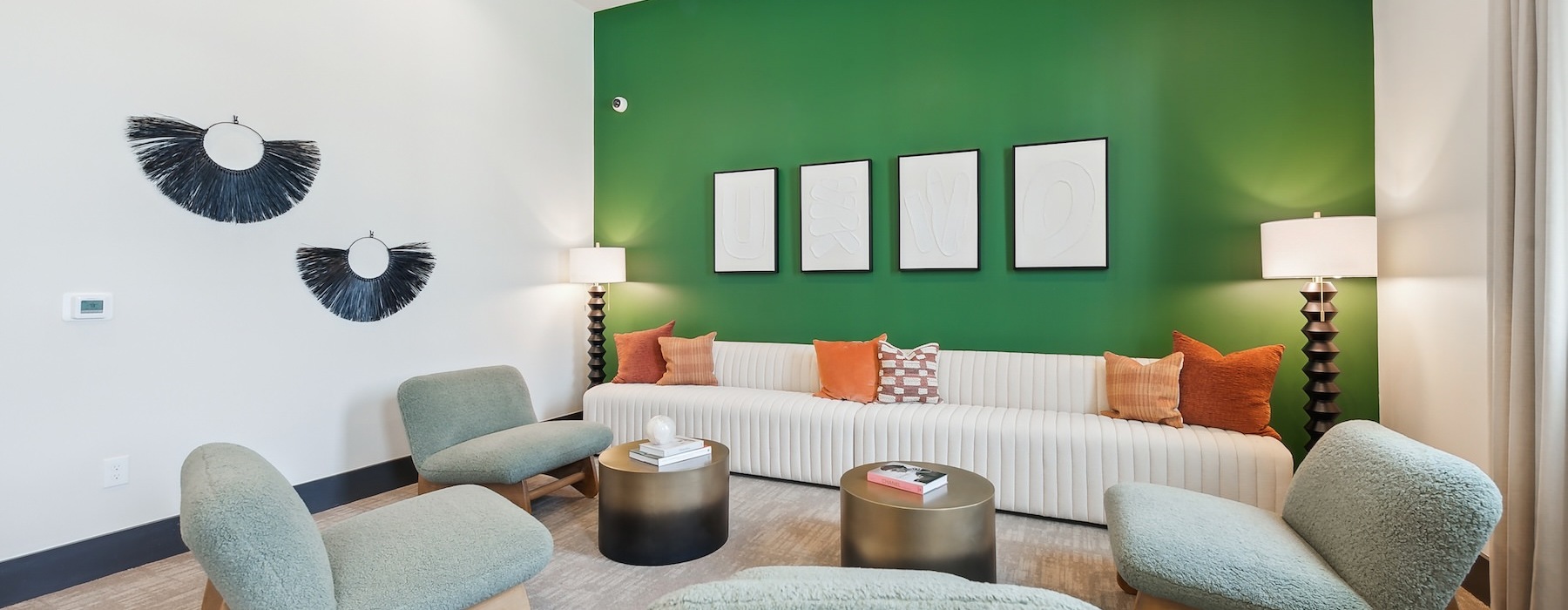 a room with a couch and chairs