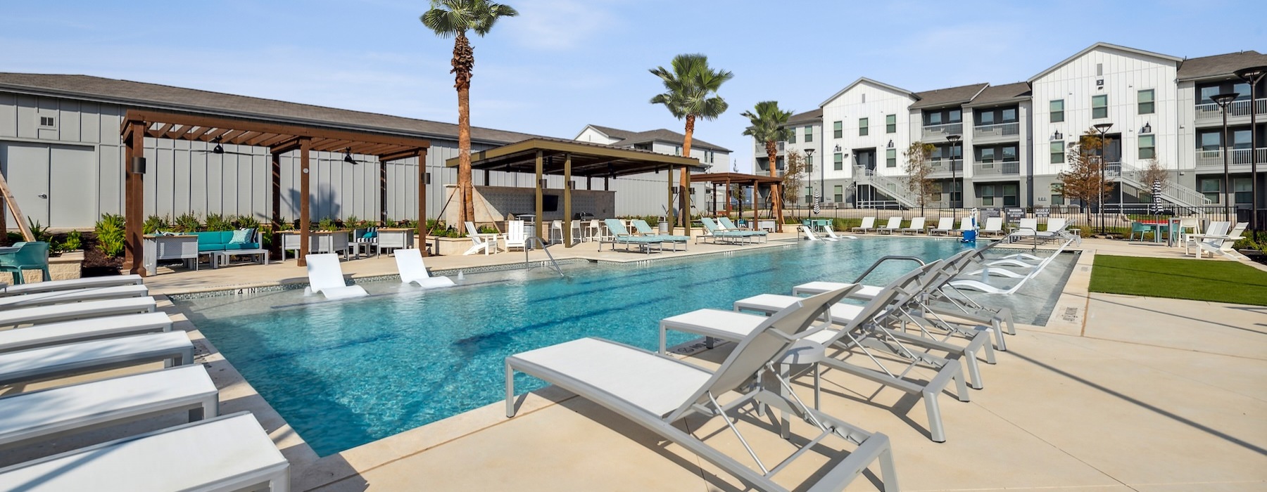 a pool with lounge chairs around it