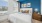 a bedroom with a bed and a fan
