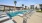 a pool with lounge chairs around it