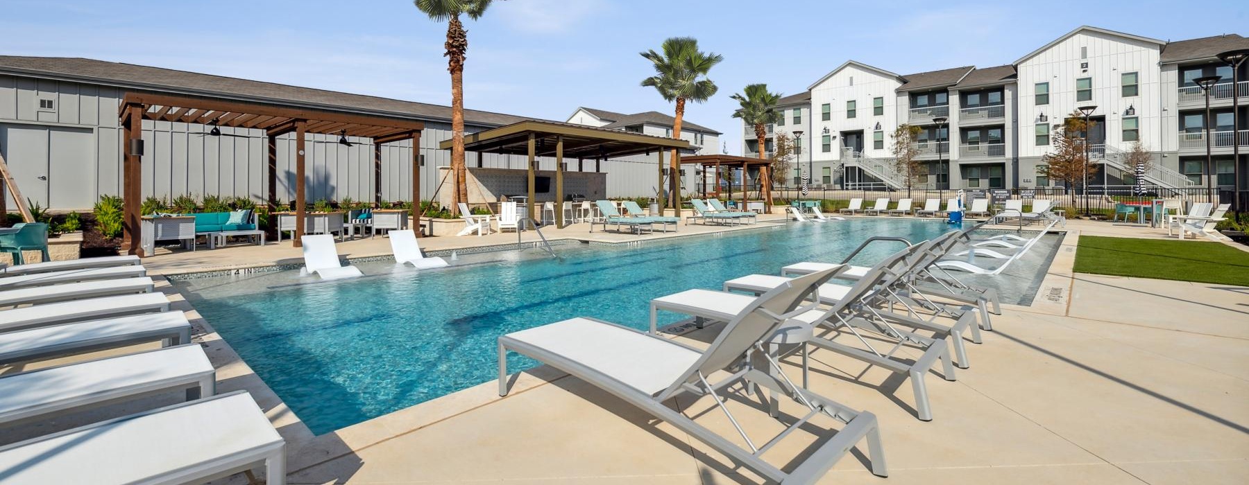 a pool with lounge chairs around it